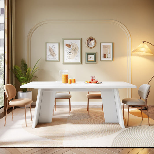 Modern dining room with a white table and chairs, decorative wall art, and a lamp.