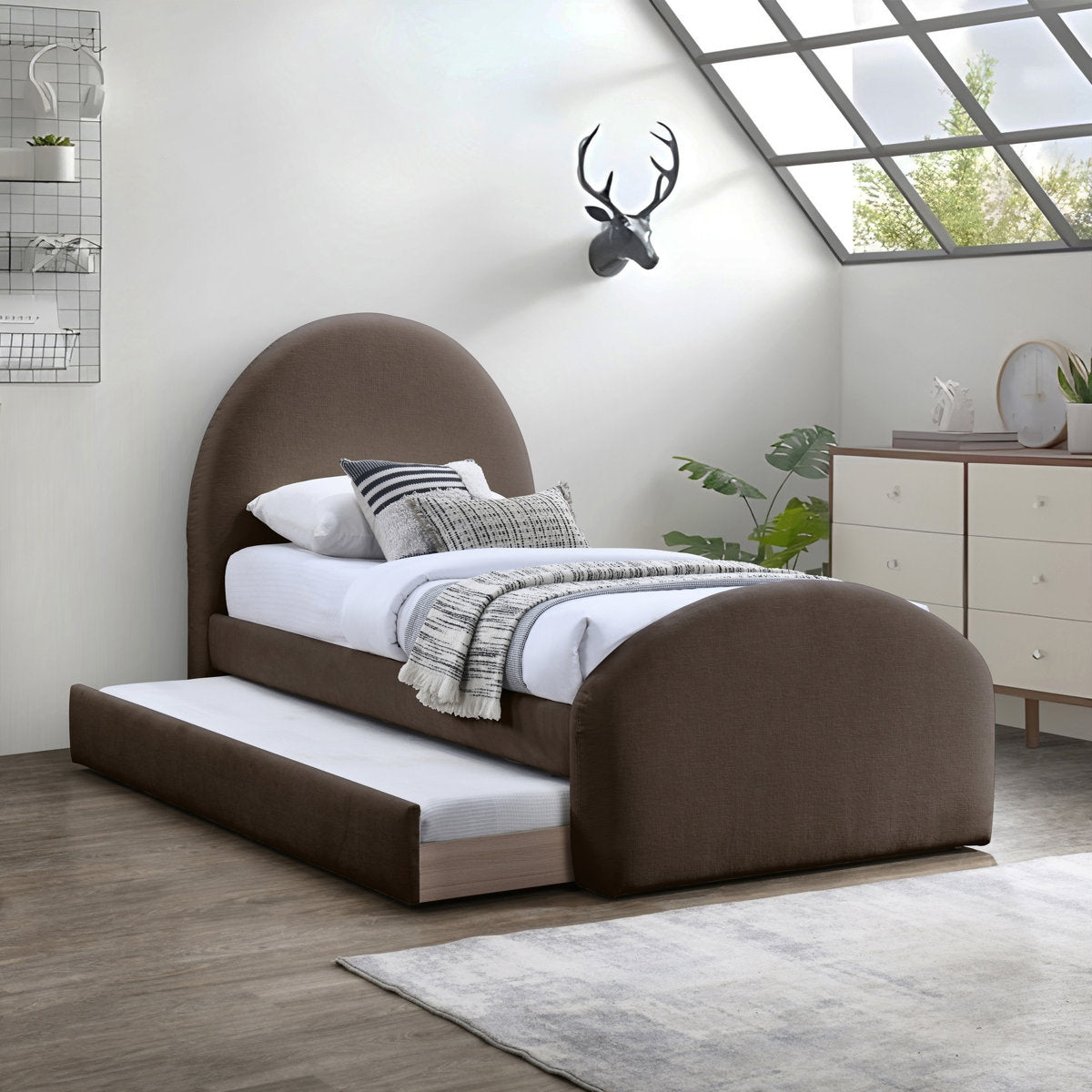 Brown upholstered bed with white bedding in a modern bedroom setting.