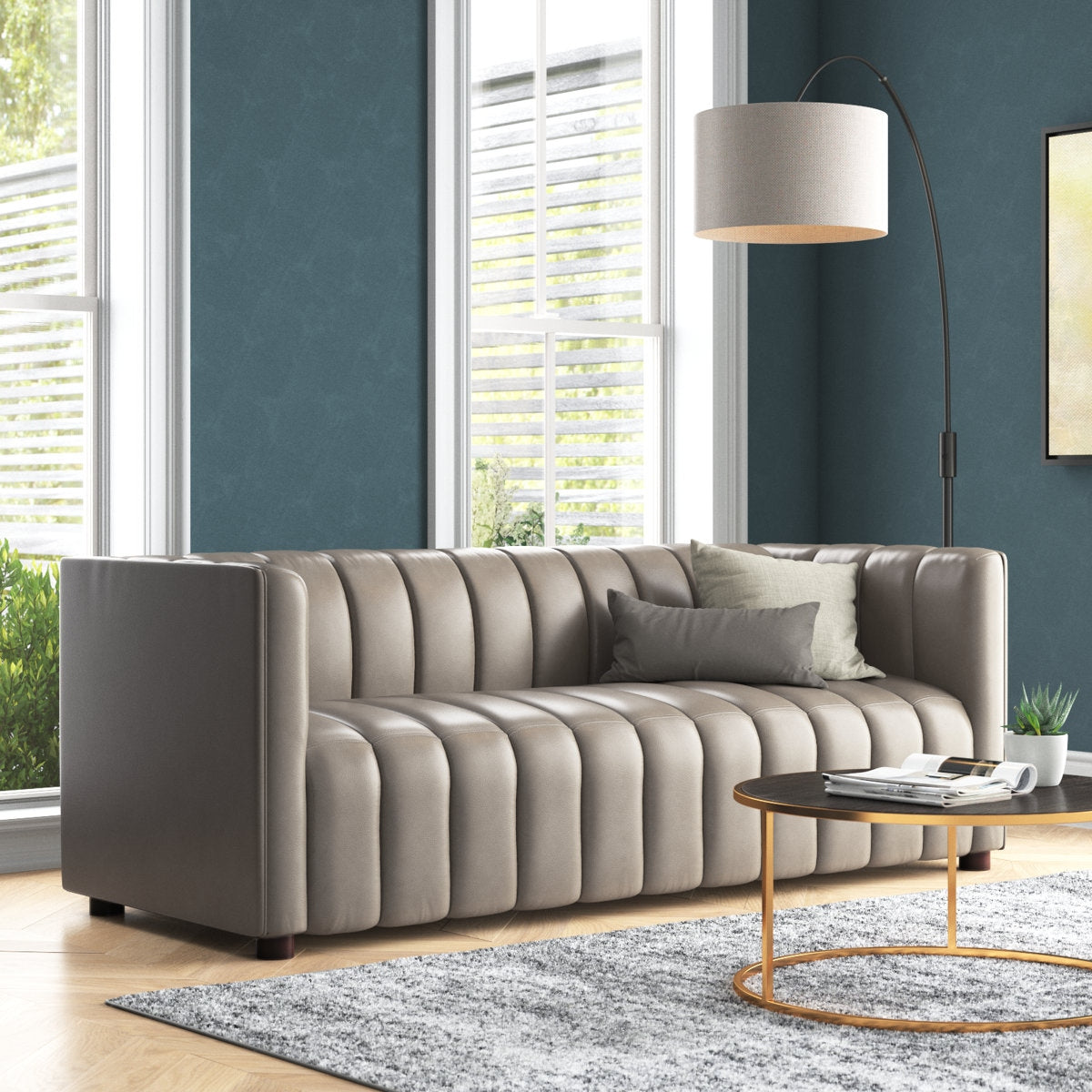 Gray sofa in a living room with a lamp and coffee table.