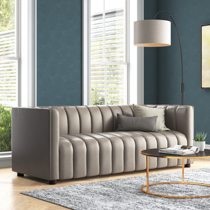 Gray sofa in a living room with a lamp and coffee table.