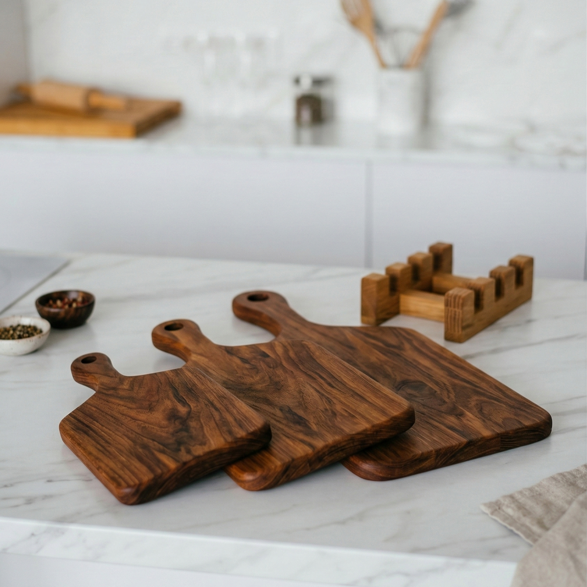 Set of wooden cutting boards on a kitchen counter with a blurred background