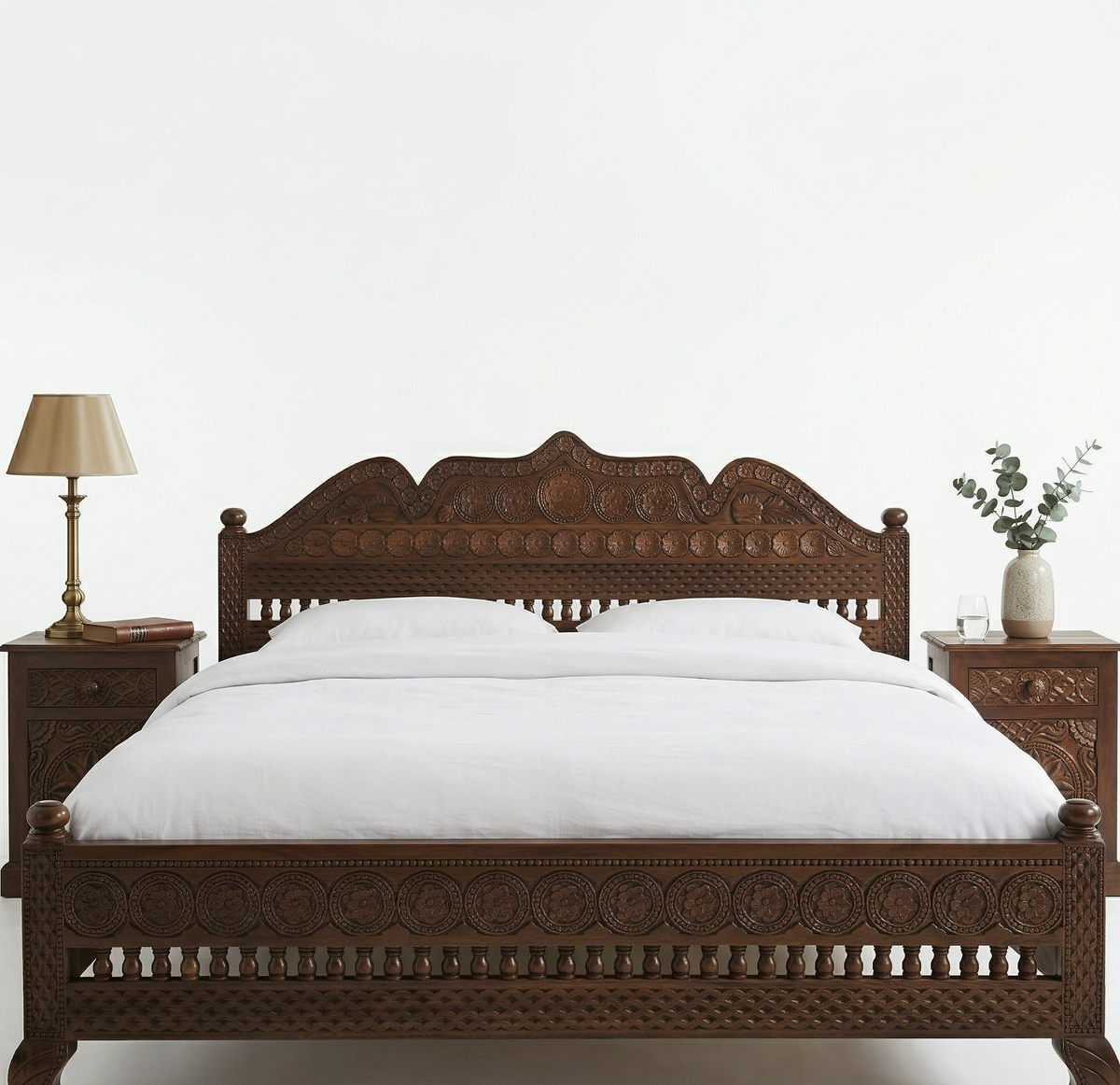Wooden bed with intricate carvings on a white background