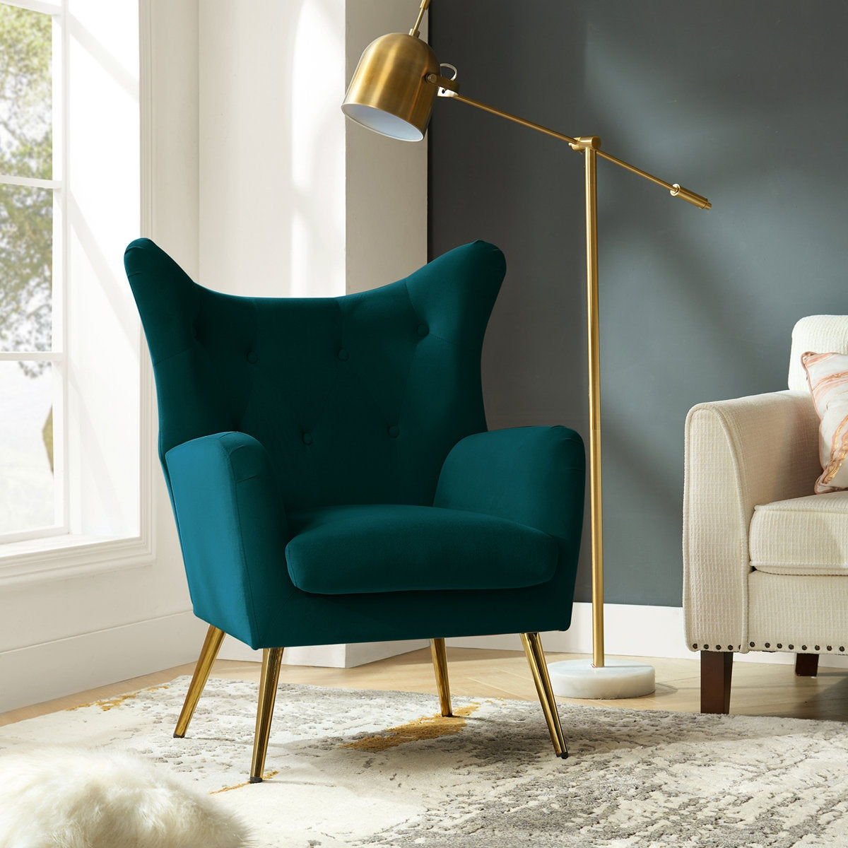 Teal armchair with gold legs in a living room setting