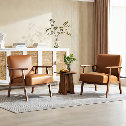 Two brown leather chairs with a small wooden table in a living room setting.