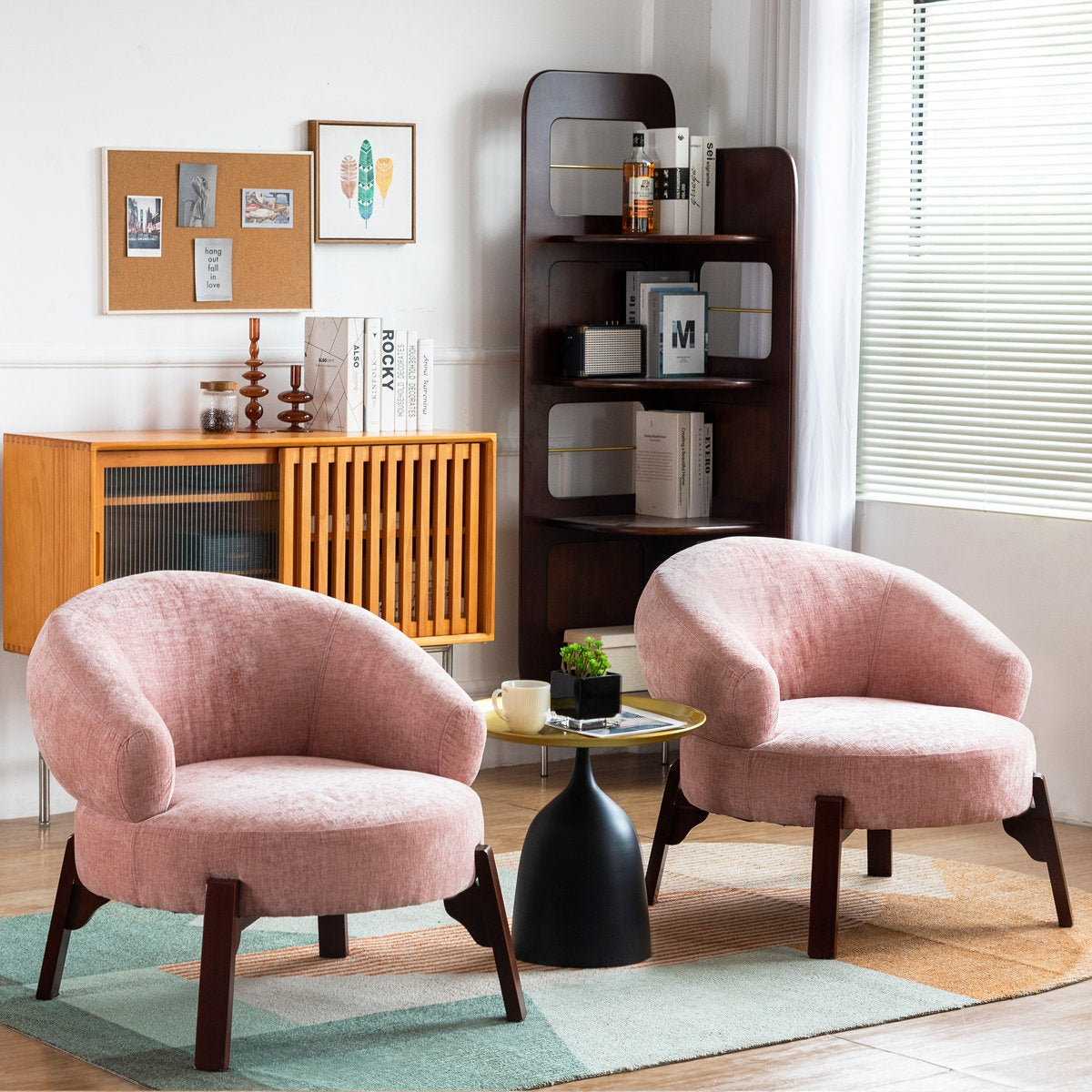 Two pink armchairs in a living room with a bookshelf and coffee table.