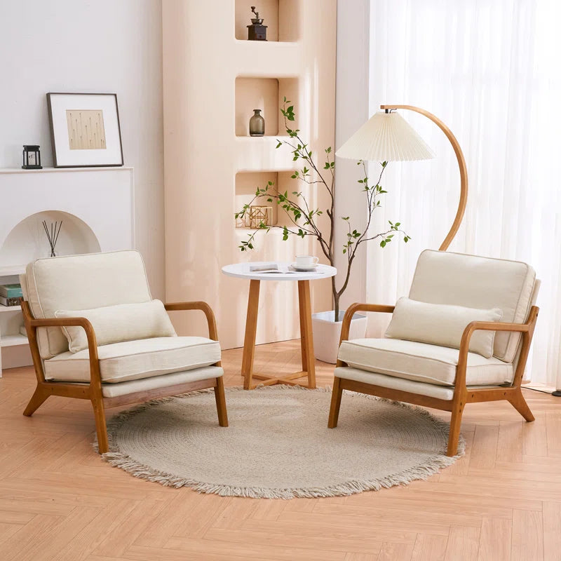 Two wooden armchairs with white cushions in a living room setting.