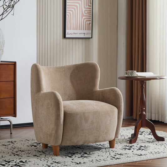 Beige armchair in a living room setting with a wooden side table and decorative elements.