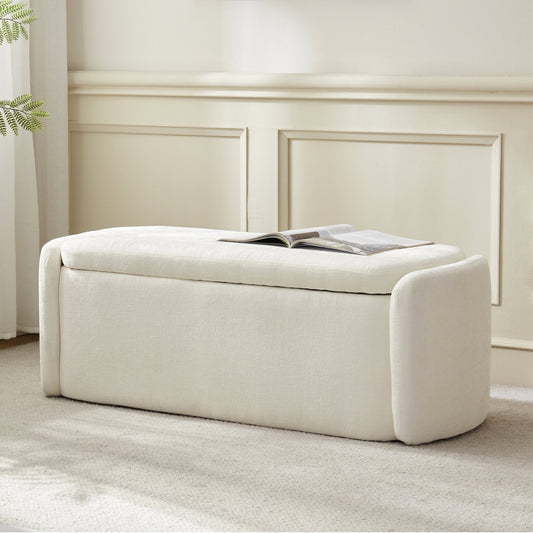 White upholstered bench with a magazine on a neutral background