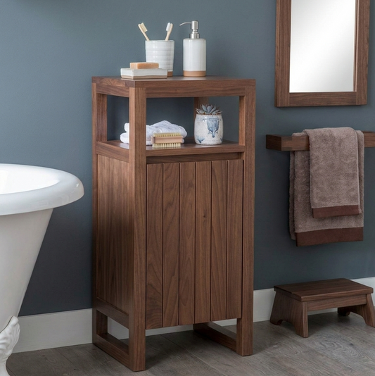 Wooden bathroom cabinet with toiletries against a gray wall