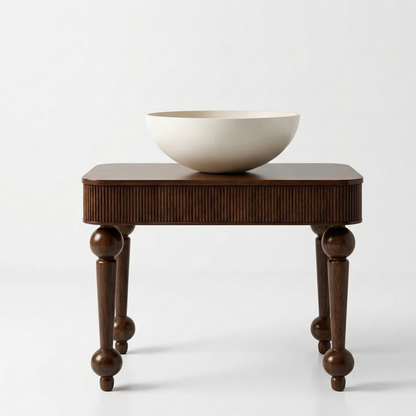 Wooden side table with a white bowl on a light gray background