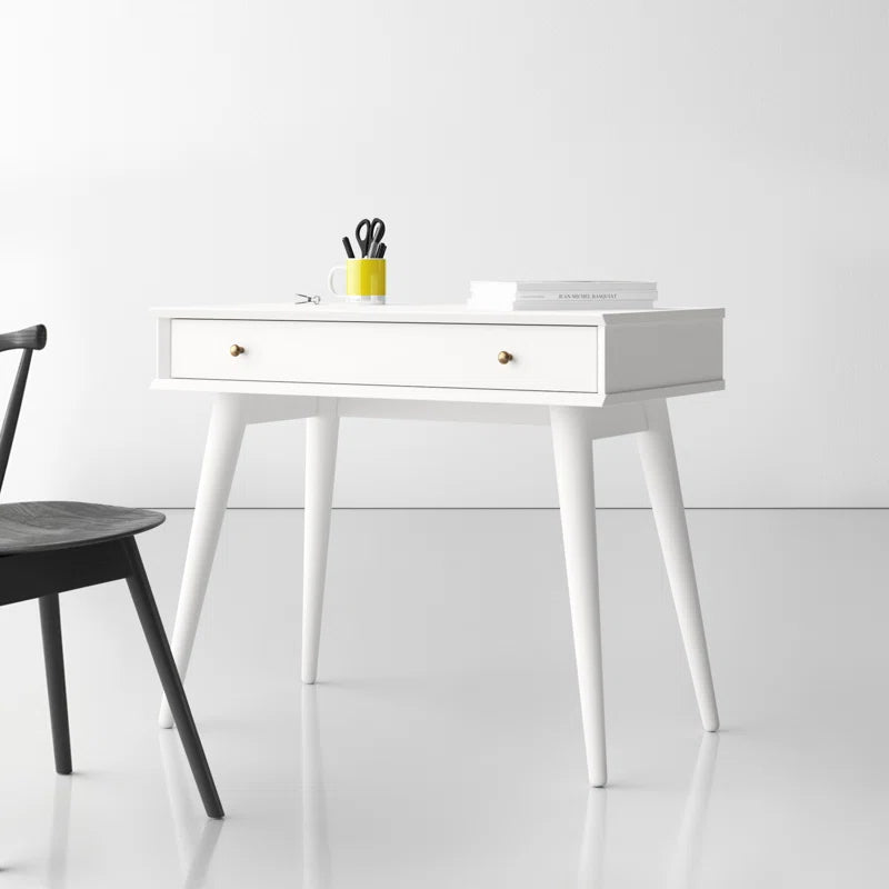 White desk with a drawer and black chair in a minimalistic room.
