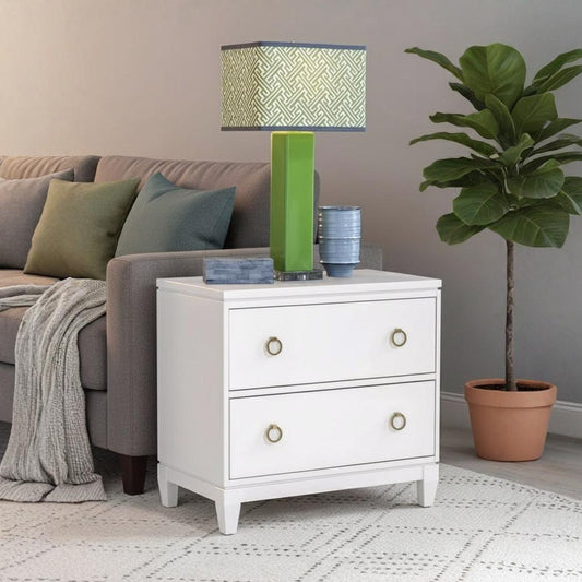 White nightstand with decorative items in a living room setting
