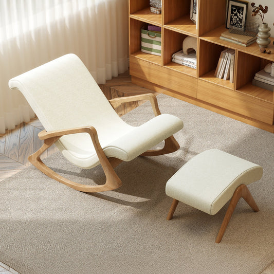 White rocking chair with wooden frame and matching ottoman in a room with wooden bookshelf.