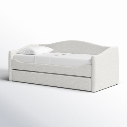 White upholstered bed with a pillow on a white background