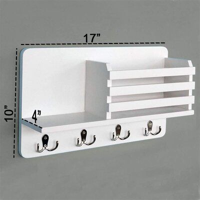 White wall-mounted shelf with hooks and measurements on a gray background