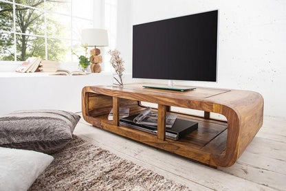 Wooden TV stand with a television in a modern living room.