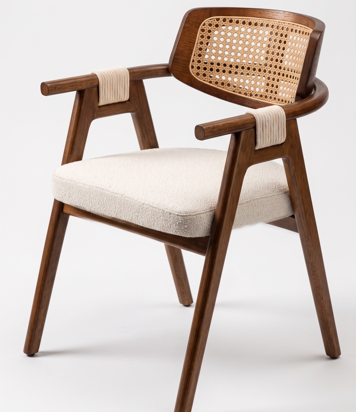 Wooden armchair with wicker backrest and white cushion on a white background
