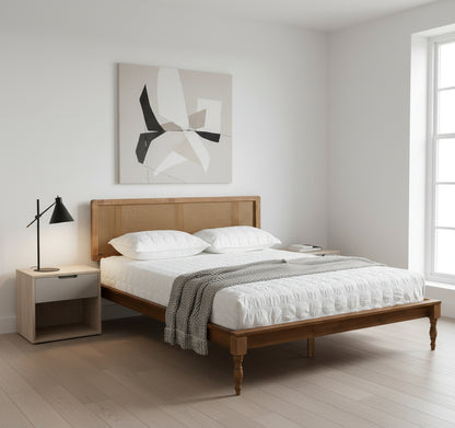 Wooden bed with white bedding in a minimalistic bedroom setting.