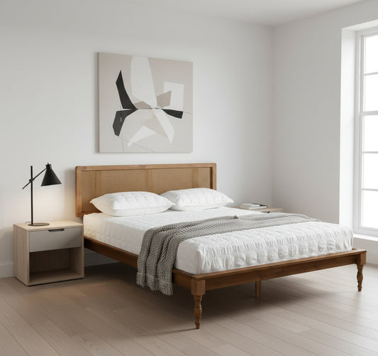 Wooden bed with white bedding in a minimalistic bedroom setting.