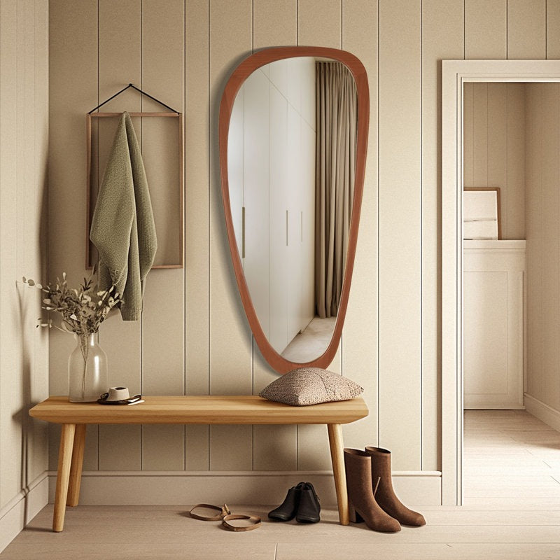 Wooden bench with a large mirror and shoes in a room with wooden flooring and walls.
