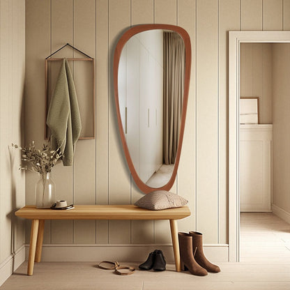 Wooden bench with a large mirror and shoes in a room with wooden flooring and walls.