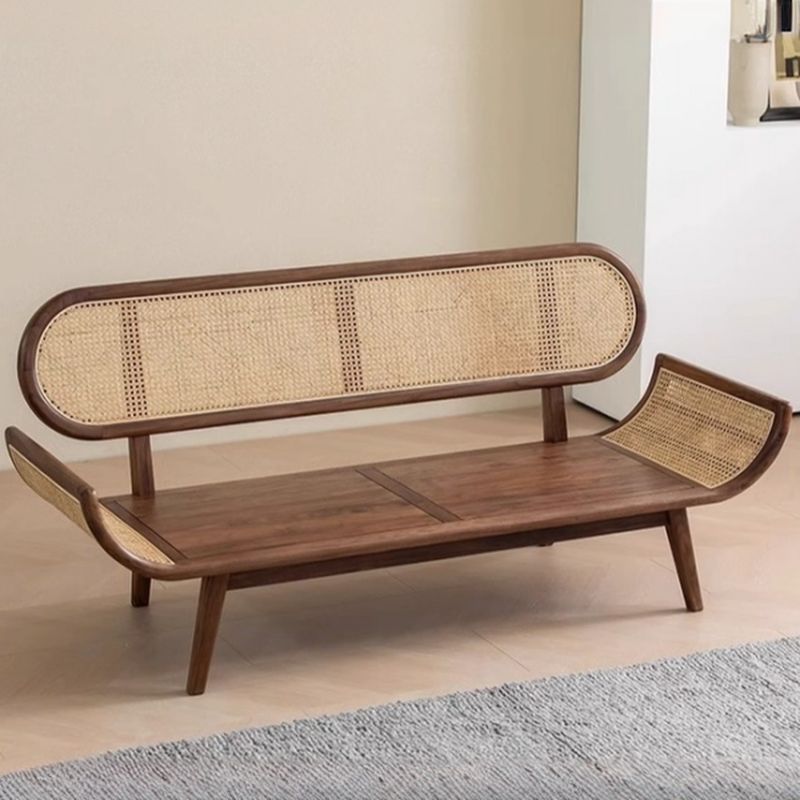 Wooden bench with wicker backrest and seat in a room setting