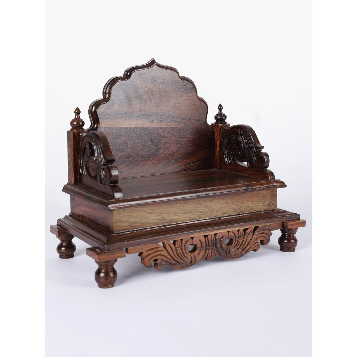 Wooden chair with intricate carvings on a white background