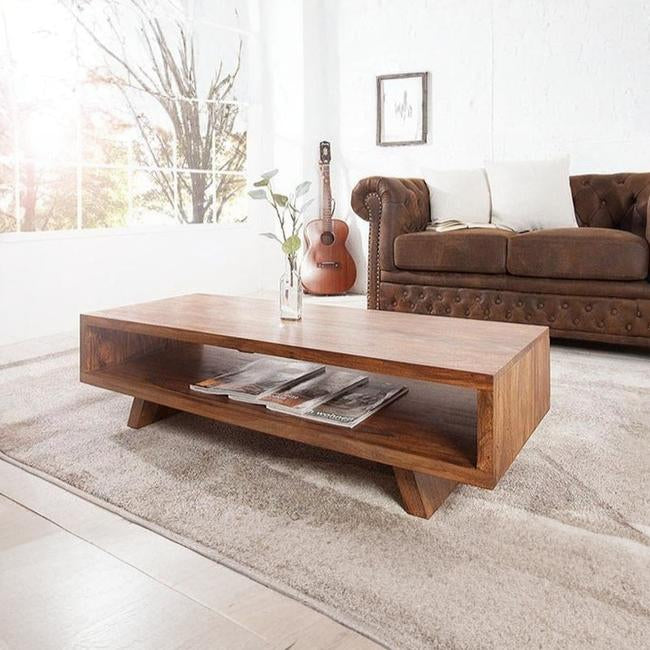 Wooden coffee table with magazines in a living room setting
