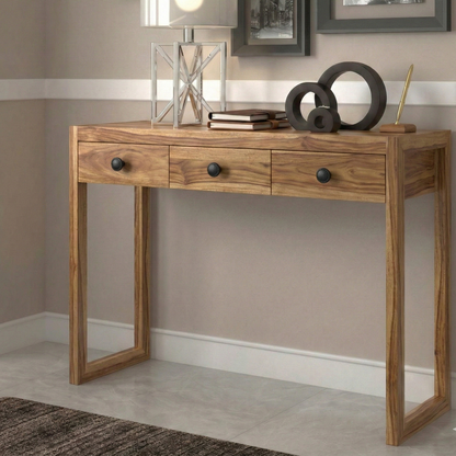 Wooden console table with decorative items against a neutral wall.