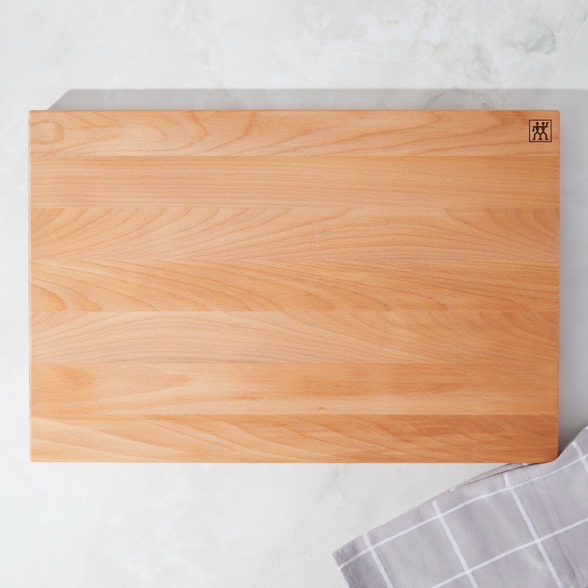 Wooden cutting board with a brand logo on a light gray background