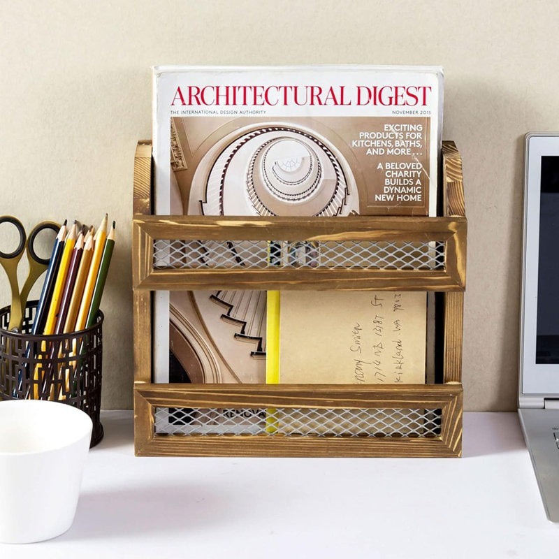 Wooden desk organizer with magazines and stationery items on a desk.