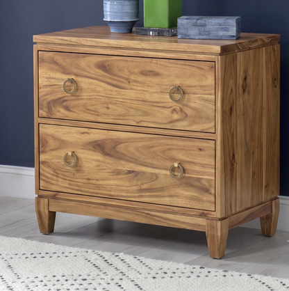 Wooden dresser with two drawers on a gray floor against a dark blue wall.