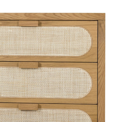 Wooden dresser with woven design on the doors against a white background