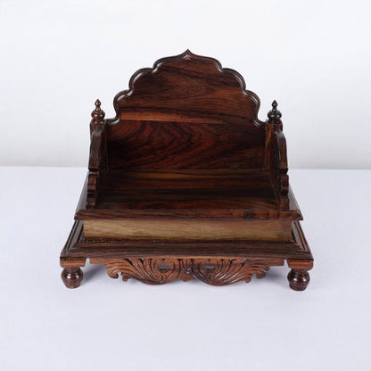 Wooden furniture piece with intricate carvings on a white background