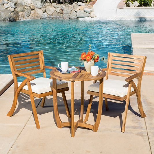 Wooden outdoor furniture set with a table and two chairs by a pool.