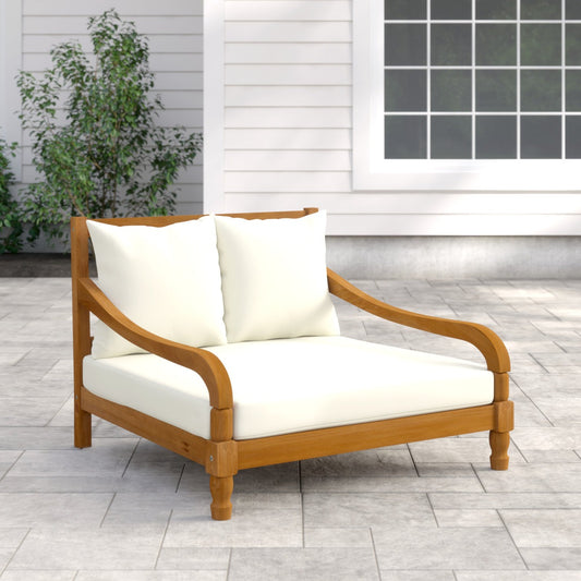Wooden outdoor loveseat with white cushions on a patio