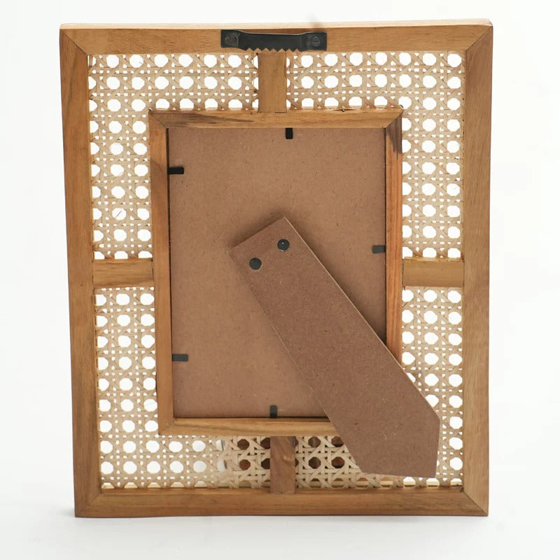 Wooden picture frame with a decorative lattice back on a white background