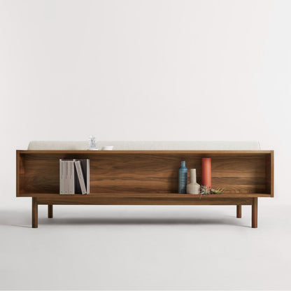 Wooden shelf with decorative items on a white background