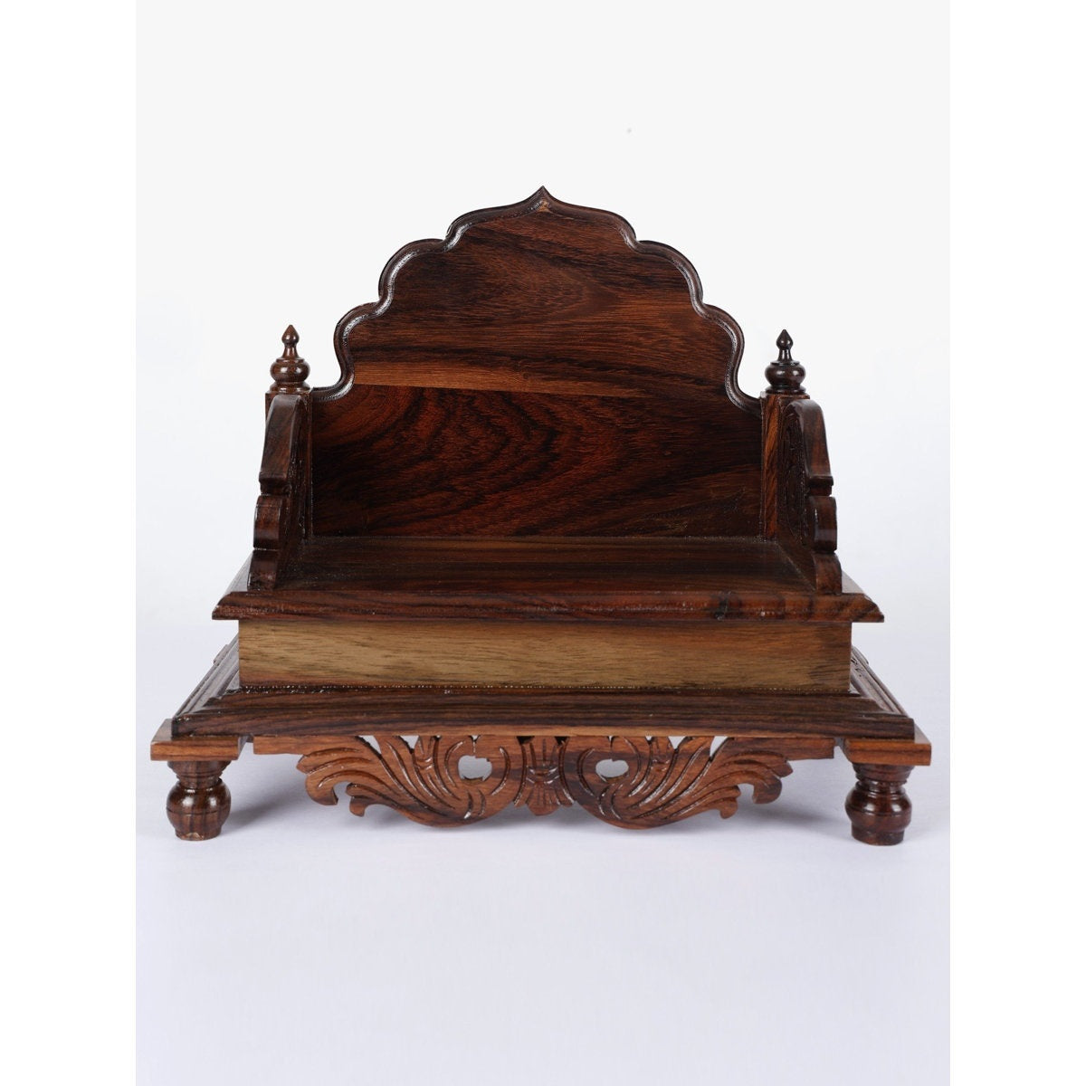 Wooden throne with intricate carvings on a white background