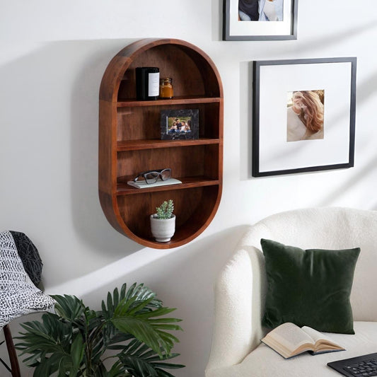 Wooden wall shelf in a living room with decor items and framed photos.