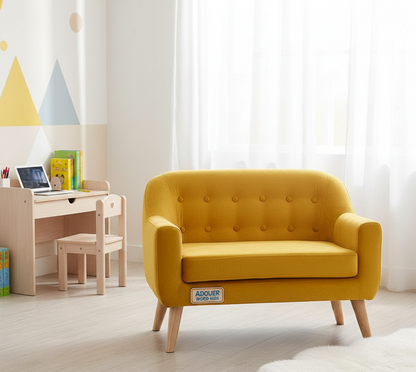 Yellow children's sofa with 'ADOUER ' branding in a room with a desk and toys.