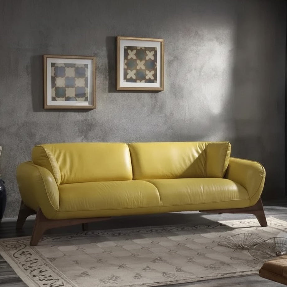 Yellow sofa in a room with gray walls and decorative frames.