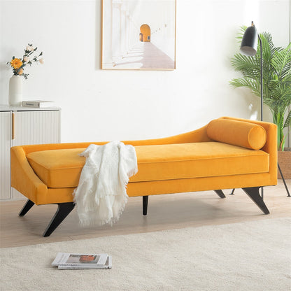 Yellow velvet bench in a modern living room with a white rug and decorative elements.