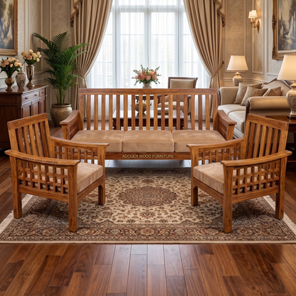 A classic wooden living room furniture set including a three-seater sofa, two matching armchairs, and a low coffee table, arranged on a patterned area rug in a richly decorated room with wood floors and curtains.