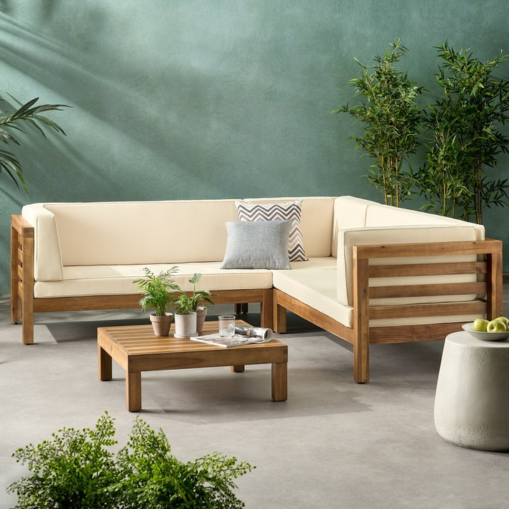 Outdoor furniture set with a sectional sofa, coffee table, and decorative elements on a patio.