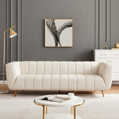 Modern living room with a beige sofa, round marble table, and decorative elements.
