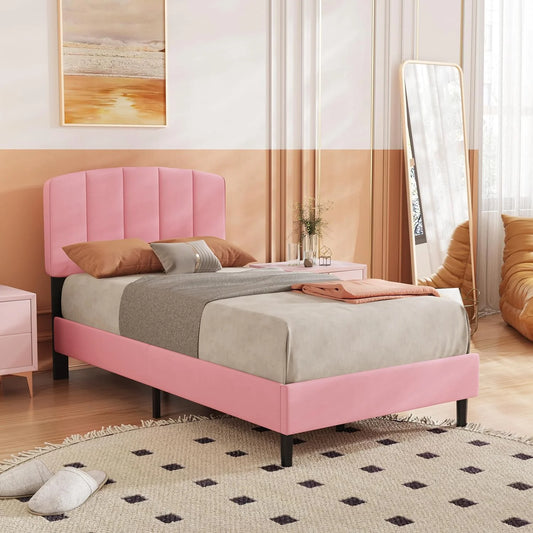 A classic upholstered platform bed with a solid sheesham wood frame in light beige and pink, with bedding and pillows on it, placed in a bedroom setting.