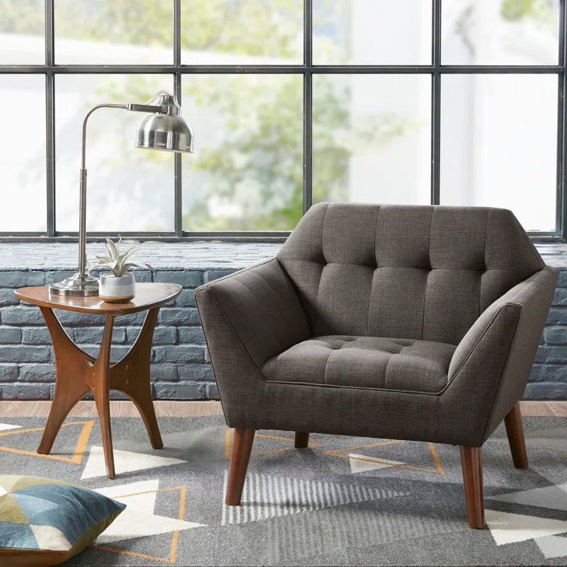 dark Gray armchair in a modern living room with large windows and a side table.
