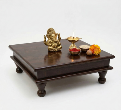Wooden altar with gold deity statue, candles, and flowers on a white background