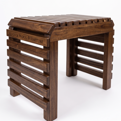 A dark brown wooden folding bench with a slatted seat, featuring the engraved brand name 'ADOUER WOOD FURNITURE' on the left side, set against a plain white background.